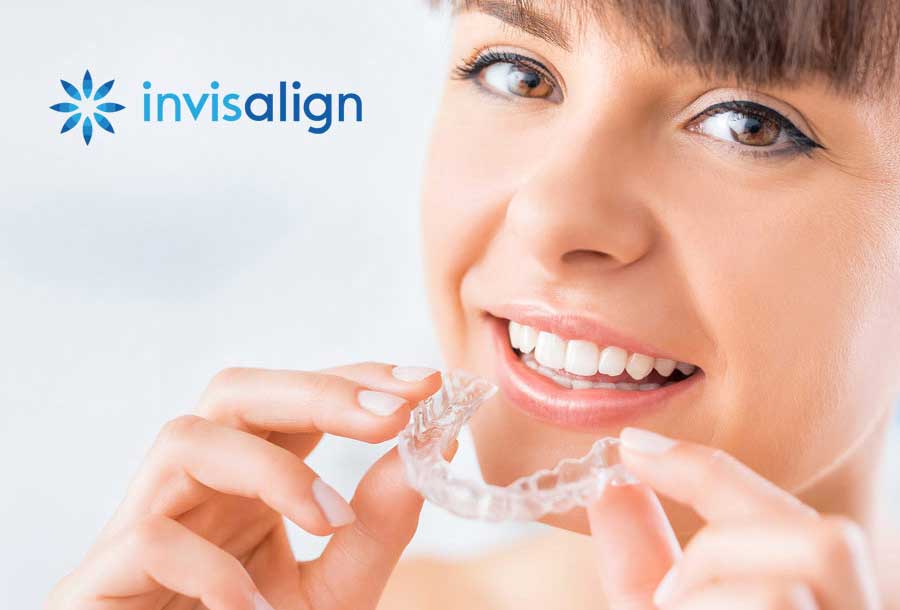 woman inserting clear invisalign appliance